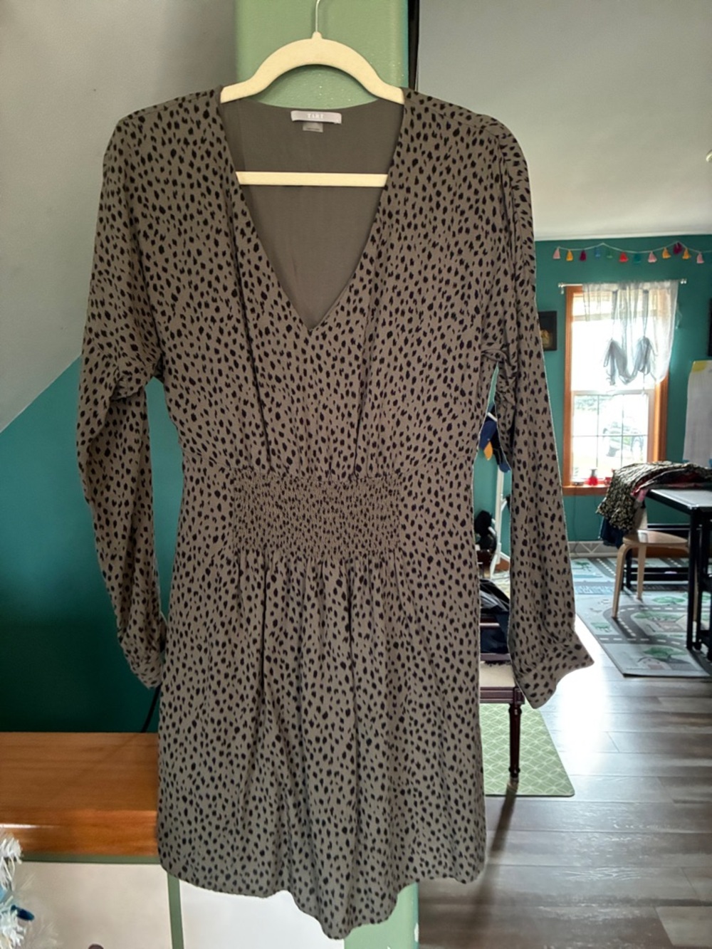 Tart Olive Green Long Sleeve V-Neck Smocked Waist Dress with Black Dots.